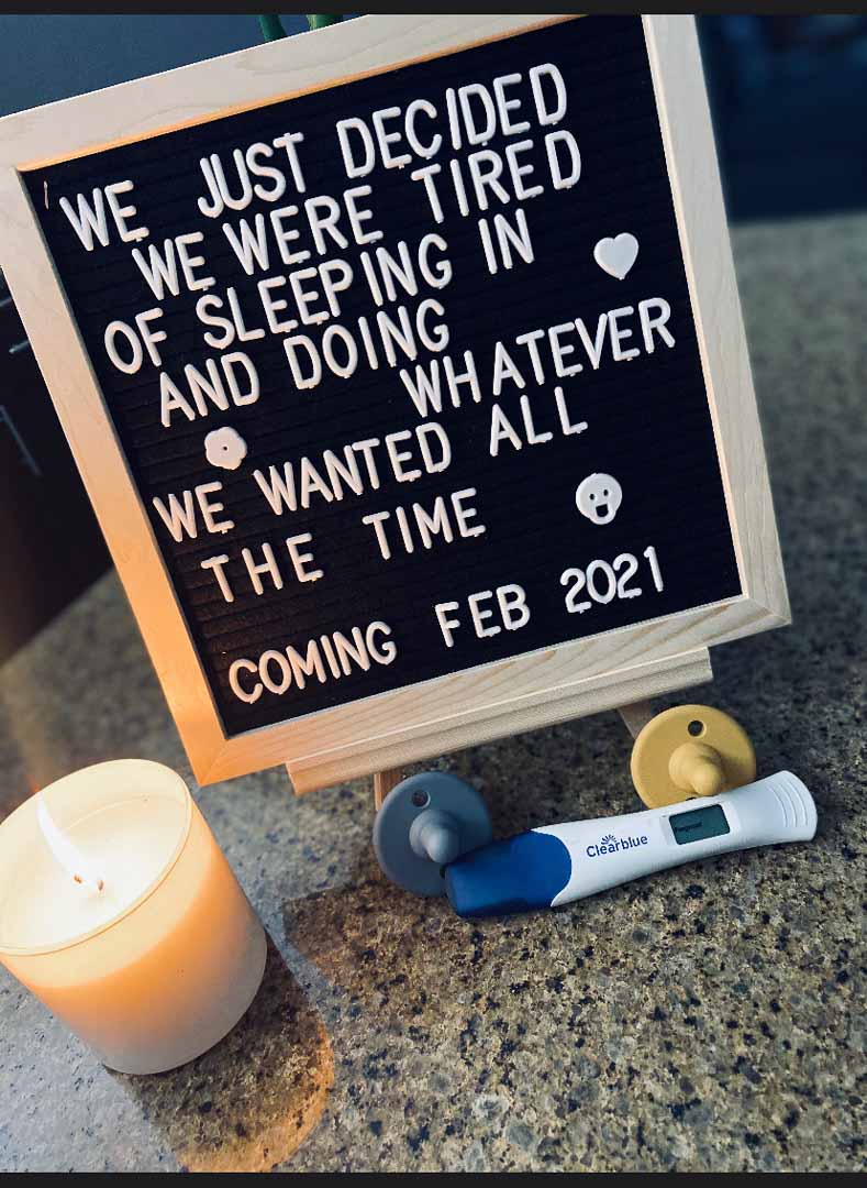 Letter board reads: "We just decided we were tired of sleeping in and doing whatever we wanted all the time, coming February 2021". Show with Positive Pregnancy Test and candle
