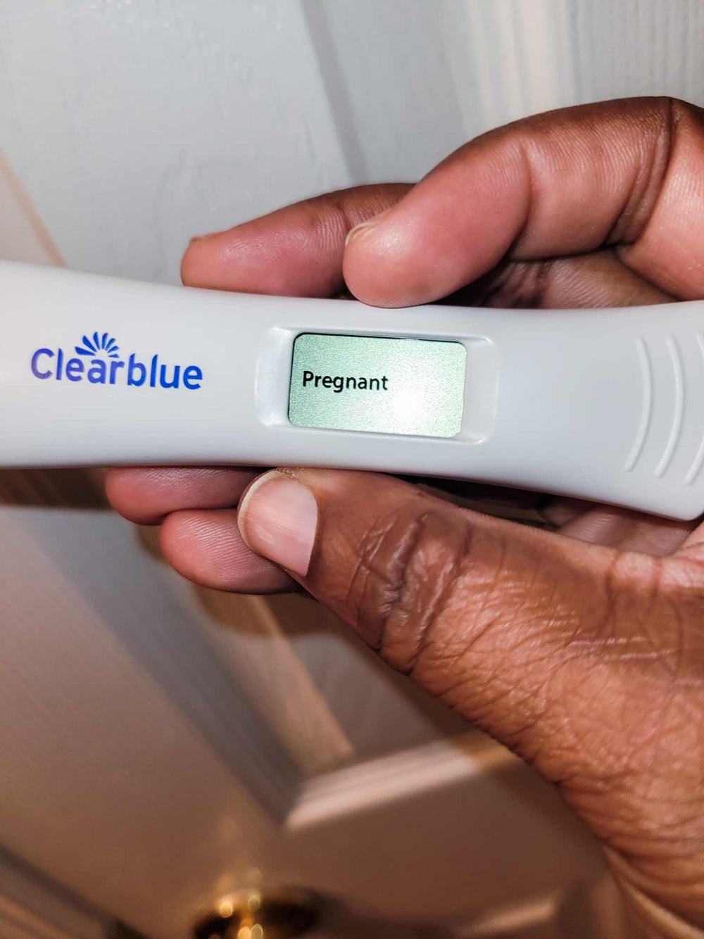 Positive pregnancy test held in Mosie mama's hand!