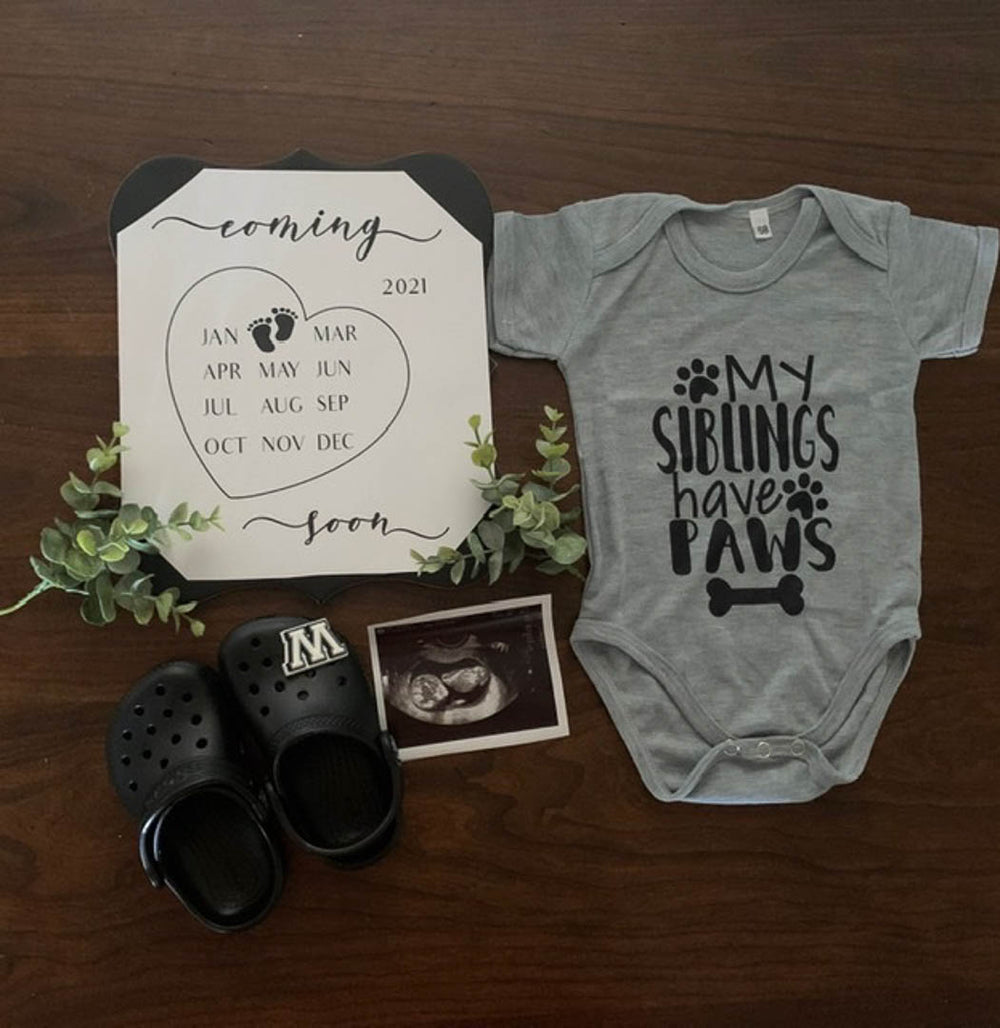 Mosie Baby announcement with onesie, due date, sonogram and shoes.