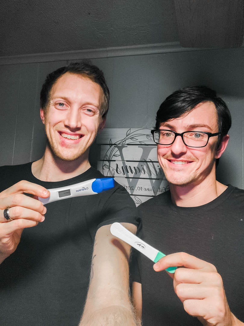 Expecting dads share pregnancy announcement in their home with positive pregnancy test .