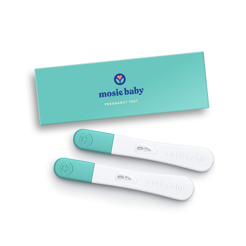 Two Mosie Baby Pregnancy Tests next to a teal rectangular box on a beige background